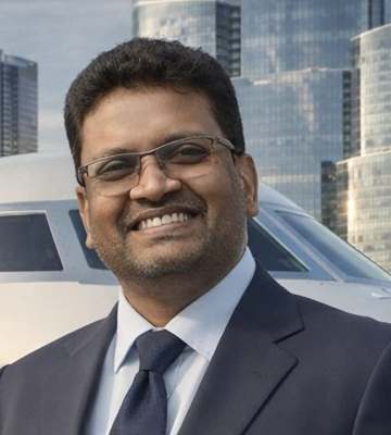 Venkat Mantri in a navy suit, smiling